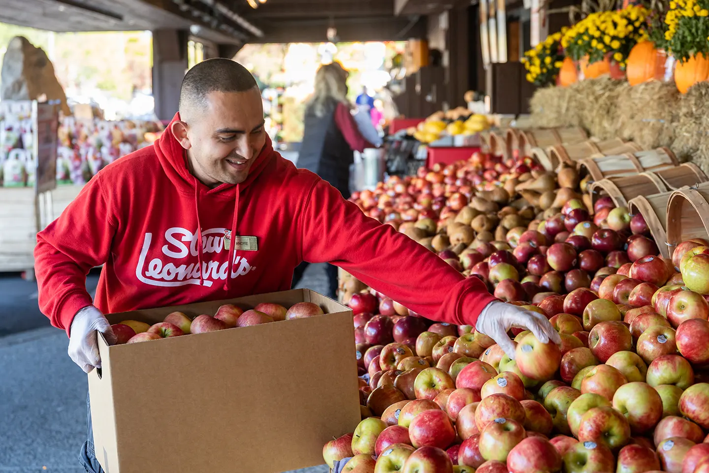 Stew's Team member filling an apple display.